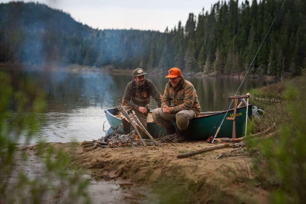 Two men fishing by a lake