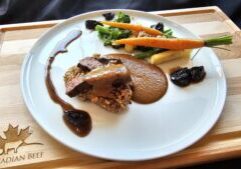 Cooks the Books: Grilled Denver Steak “Bakareta” with tomato liver sauce, California Walnut crusted rice cake and glazed California Prunes.